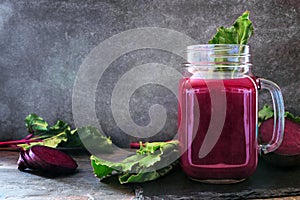 Beet juice in a mason jar with ingredients against a dark background