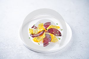 Beet orange cilantro salad with spicy olive oil vinegar sauce in a plate