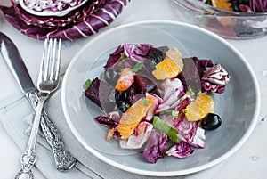 Beet, orange, radicchio, olives salad. Close-up