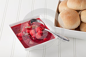 Beet Soup Borscht with bowl of rolls