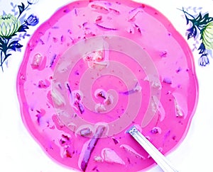 Beet soup in white plate