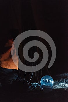 Beetle in a crystal ball at night in traditional decor for the holiday Halloween