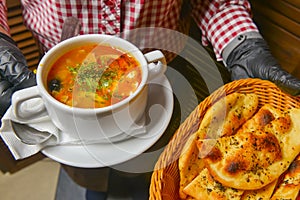 Beetroot and cabbage soup, borshch. Waiter serving dinner at restaurant or diner, eating out concept
