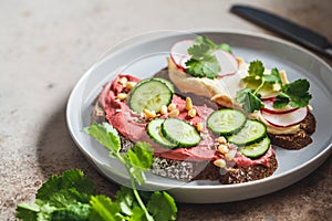 Beetroot and classic hummus toasts. Vegan food concept