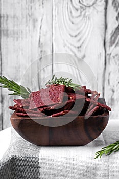 Beetroot crispbreads for healthy nutrition in a wooden bowl