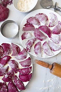 Beetroot Pasta ravioli in the making against white background. Top view, flat lay, copy space