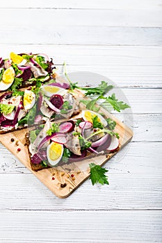 Beetroot and Pickled Marinated Herring Open Sandwich on Rye Bread