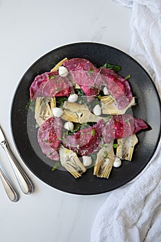 Beetroot Ravioli/Pelmeni filled with Ricotta-Goat cheese, sauteed Artichokes hearts in a sage butter sauce