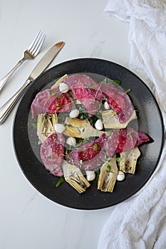 Beetroot Ravioli/Pelmeni filled with Ricotta-Goat cheese, sauteed Artichokes hearts in a sage butter sauce