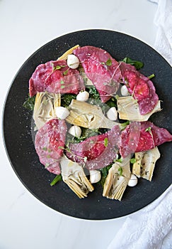 Beetroot Ravioli/Pelmeni filled with Ricotta-Goat cheese, sauteed Artichokes hearts in a sage butter sauce