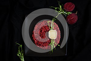 Beetroot risotto with goat cheese and green sprouts