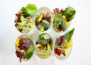 Beetroot salad with avocado and herring in cream sauce in a glass.