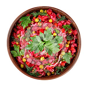 Beetroot salad vinaigrette in a clay bowl isolated on white. Top view.