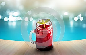 Beetroot smoothie healthy and mint herb on wooden and blue swiming pool background