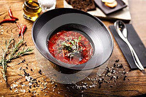 Beetroot soup Borscht with meat and sourcream in a bowl. Delicious healthy Russian traditional food closeup served for