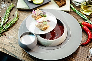 Beetroot soup Borscht with meat and sourcream in a bowl. Delicious healthy Ukrainian traditional food closeup served for