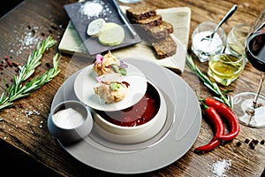 Beetroot soup Borscht with meat and sourcream in a bowl. Delicious healthy Ukrainian traditional food closeup served for