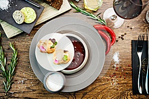 Beetroot soup Borscht with meat and sourcream in a bowl. Delicious healthy Ukrainian traditional food closeup served for