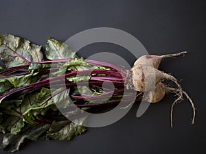 Beetroots with leaves isolated on black background