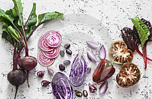 Beets, red cabbage, tomatoes, beans, peppers, onions, Swiss chard on a light background, top view. Food vegetables background.