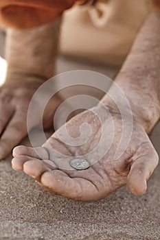 Beggar hand with coin photo