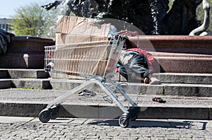 The beggar sleeps on the steps, European city