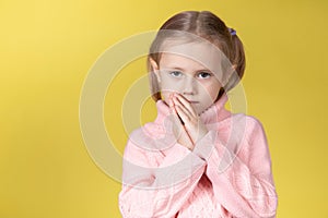 Begging little caucasian elementary age school girl looking at the camera