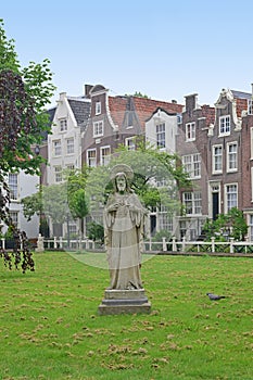 Begijnhof at Amsterdam with Jesus statue in the centre surrounded by a group of historic buildings