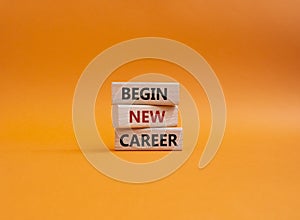 Begin new career symbol. Concept word Begin new career on wooden blocks. Beautiful orange background. Business and Begin new