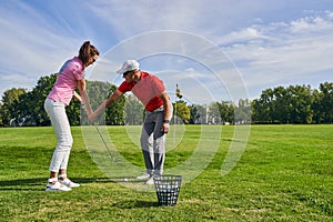 Beginner female golfer learning a proper golf grip