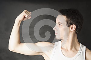 Beginner man showing his muscular
