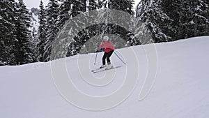 Beginner Skier Carefully Skiing Down The Slope On Skis In The Mountain Resort