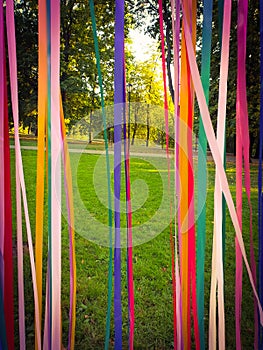 The beginning of autumn, an idealistic landscape.  Sunny day, view of the park through multi-colored satin ribbons