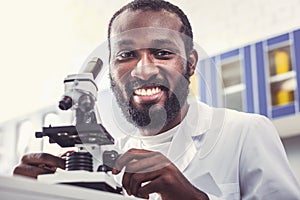 Beginning microbiologist smiling working in lab