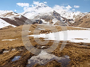 The beginning of spring in the mountains. Snow melting, sunny weather. Georgia Caucasus Mountains