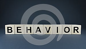 Behavior - word on cubes on a blue background