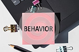 Behavior word written on a paper sticker