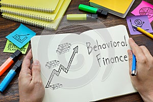 Behavioral finance is shown on the business photo using the text