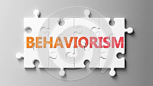 Behaviorism complex like a puzzle - pictured as word Behaviorism on a puzzle pieces to show that Behaviorism can be difficult and photo