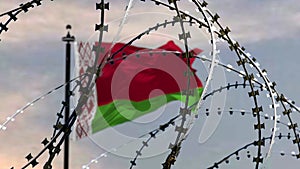 Behind barbed wire flag of Belarus against the sky, 3d rendering. Concept: international sanctions, totalitarian regime,