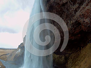 Behind the curtains of seljalandsfoss waterfall, iceland