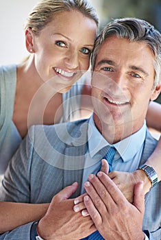 Behind every man is a great woman. Portrait of a smiling mature business couple.