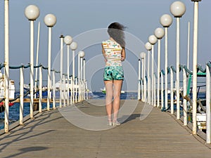 Behind girl on pier