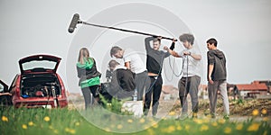 Behind the scene. Film crew filming movie scene outdoor