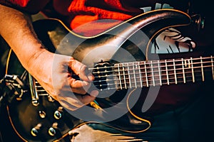 Behind scene. Guitarist practice playing guitar in messy music s