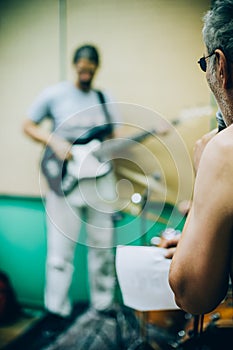 Behind scene. Rock band practice in messy recording music studio