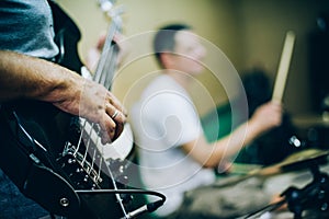 Behind scene. Rock band practice in messy recording music studio