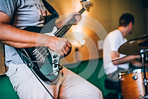 Behind scene. Rock band practice in messy recording music studio