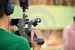 Behind the scenes of filming movies or video products. The operator with the camera on the set selects the shooting shot