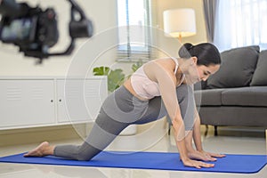 Behind the scenes of Fit young woman doing yoga and meditation at home, sport and healthy lifestyle concept